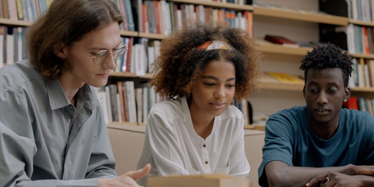 A diverse group of people engaged in an intense intellectual discussion, fostering community.