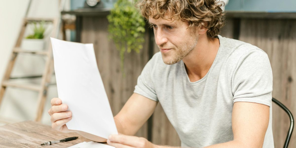 A person diligently reviews documents, applying evidence-based reasoning to overcome personal biases and subjectivity.