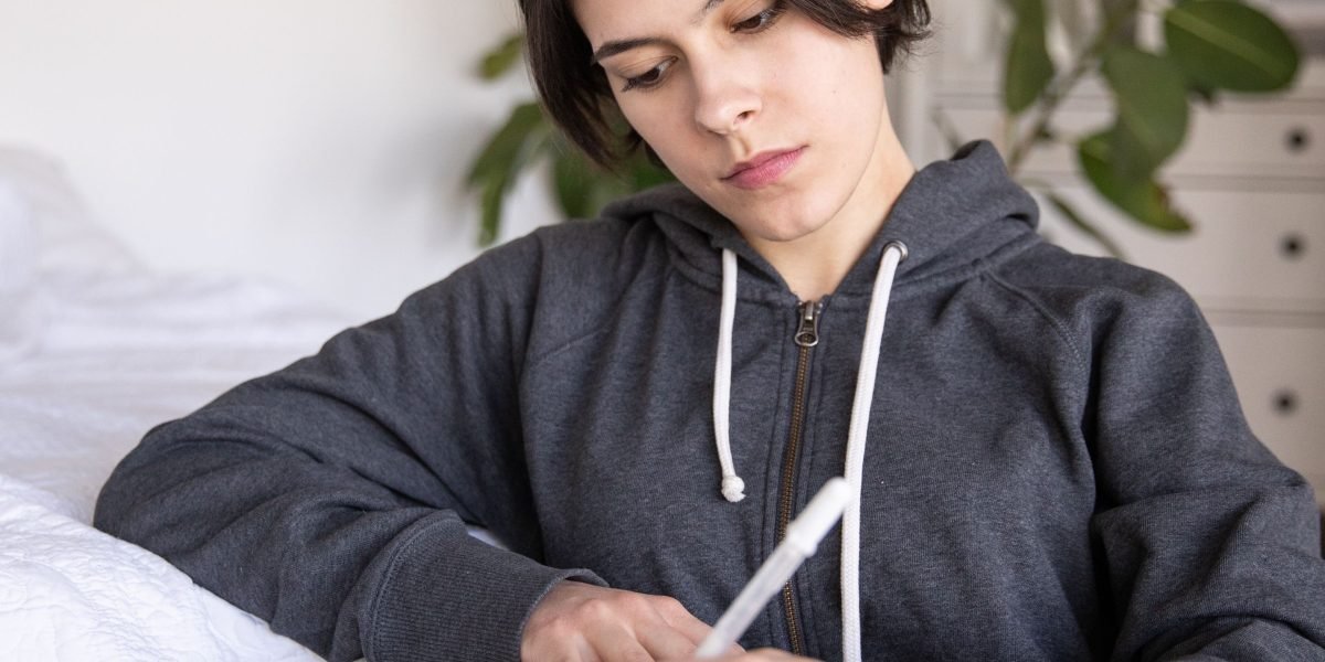 A person calmly writing in a journal, practicing self-reflection to overcome cognitive biases and emotional influence.