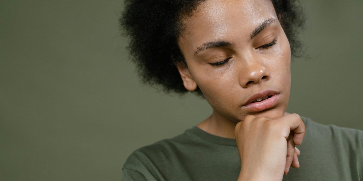 A person sitting calmly, looking thoughtful and composed, symbolizing clarity amid information overload and decision-making.