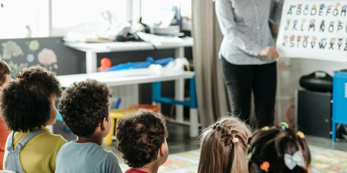A teacher engaging a group of young children through expressive storytelling.