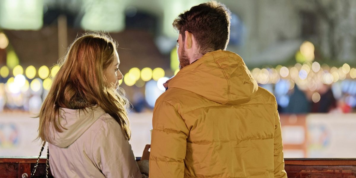 Two people engaged in a serious but supportive conversation, depicting concern and empathy in a clinical or personal context.