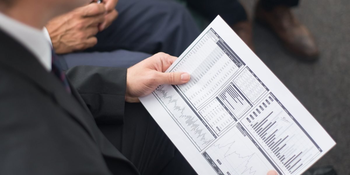 A manager reviewing data on a dashboard, assessing employee performance and training impact.