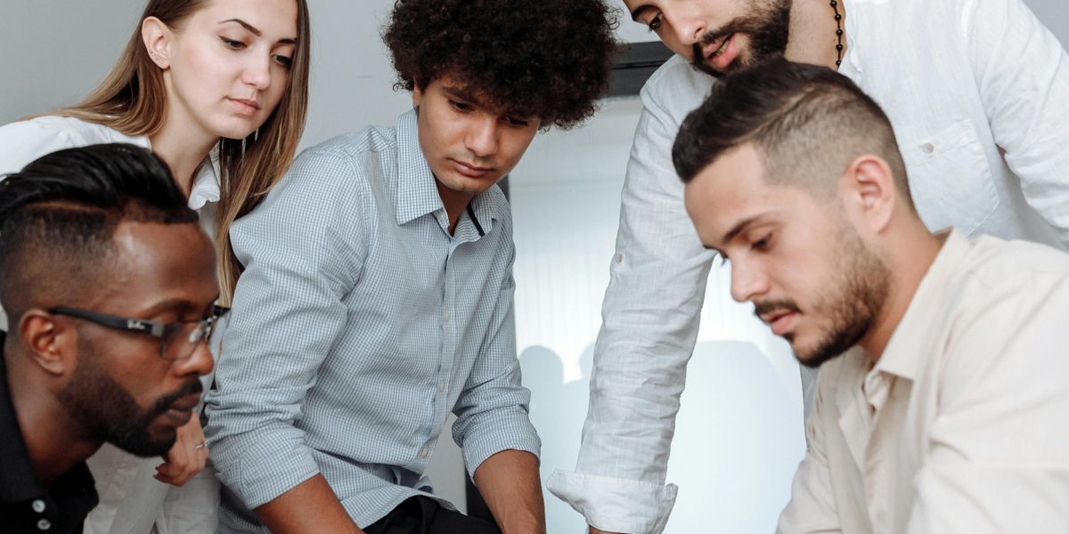 A diverse group of people engaging in a lively discussion during a workshop or classroom activity.