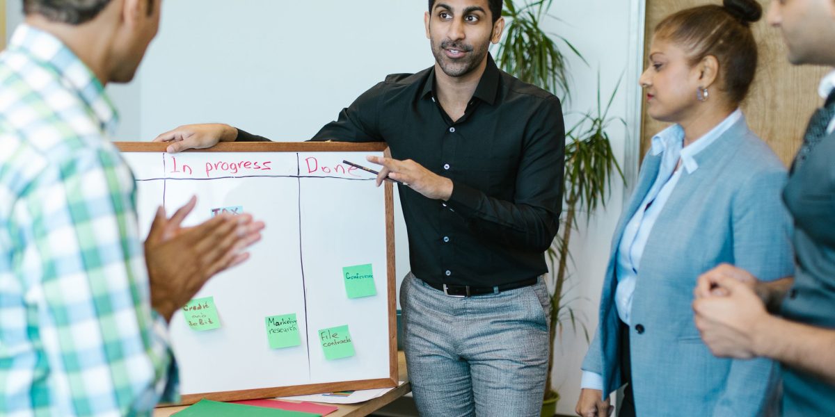 A team discusses and evaluates digital learning systems, applying critical thinking to make informed strategic decisions.