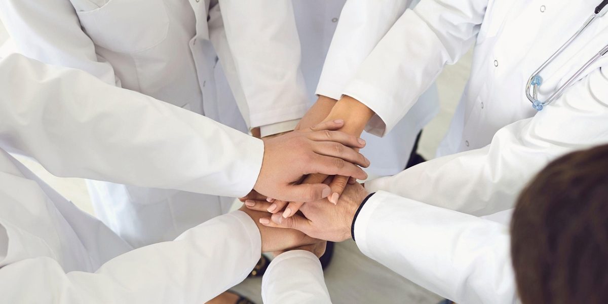 Healthcare professionals collaborate, highlighting the essential need for a strong, well-trained workforce.
