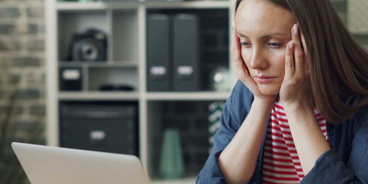 A person visibly overwhelmed by the constant barrage of digital notifications and content.