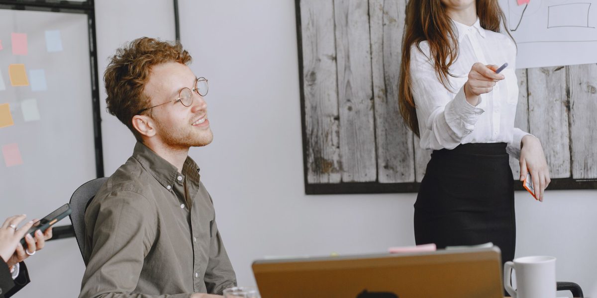 A confident individual presenting their ideas in a professional setting, effectively communicating complex concepts to an audience.