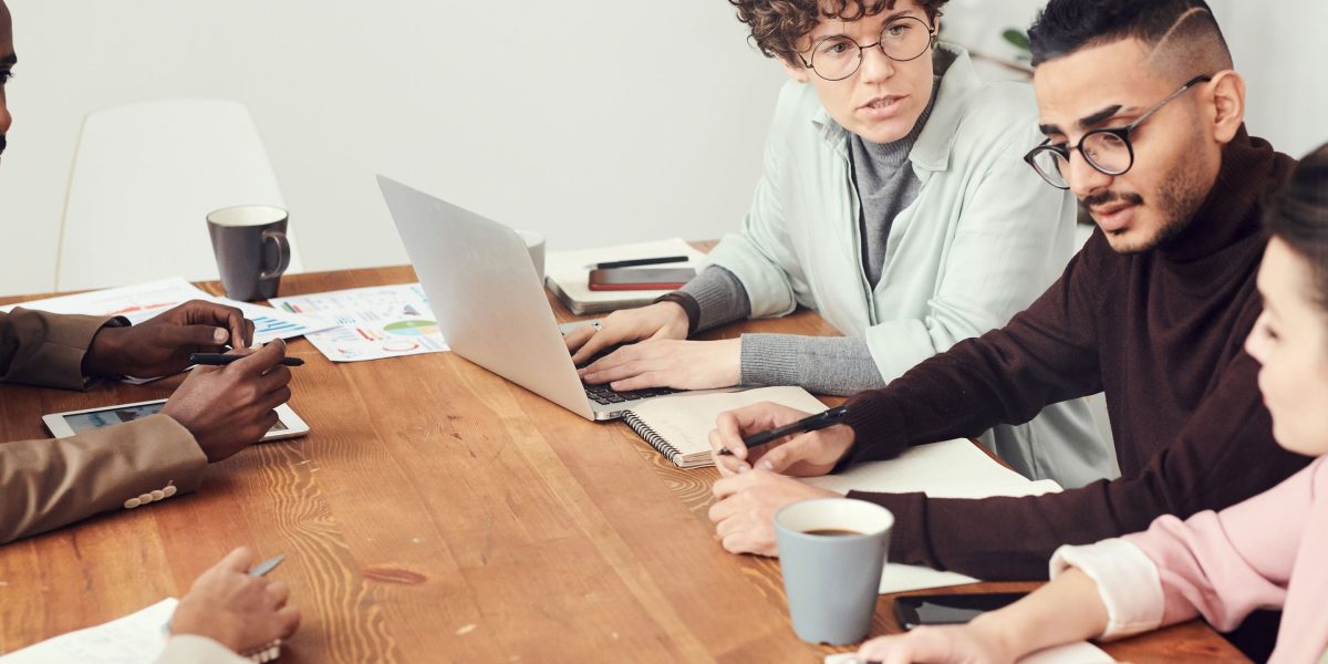 A diverse team collaborating, analyzing data and discussing research findings in an office setting.