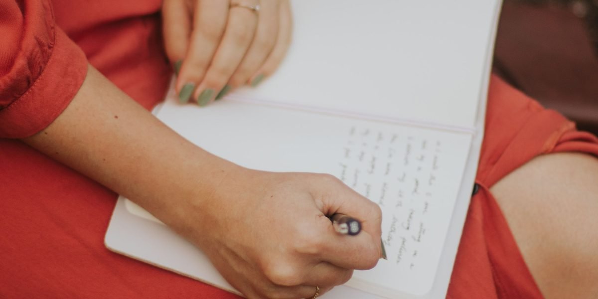 A person engaged in journaling, a practical method for calibrating and improving intuition.